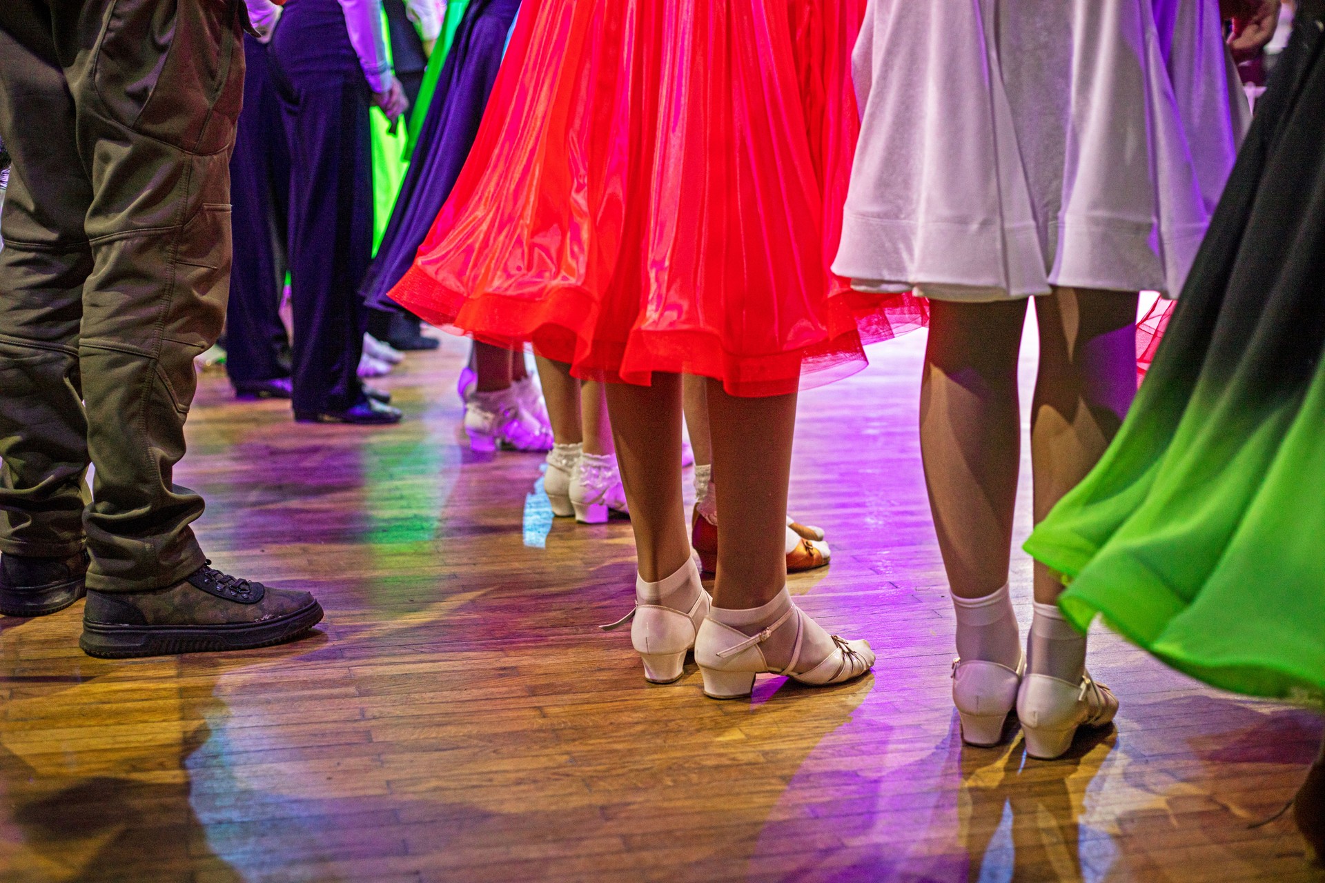 girls in ballroom dancing shoes and beautiful dresses at a ballroom dancing tournament