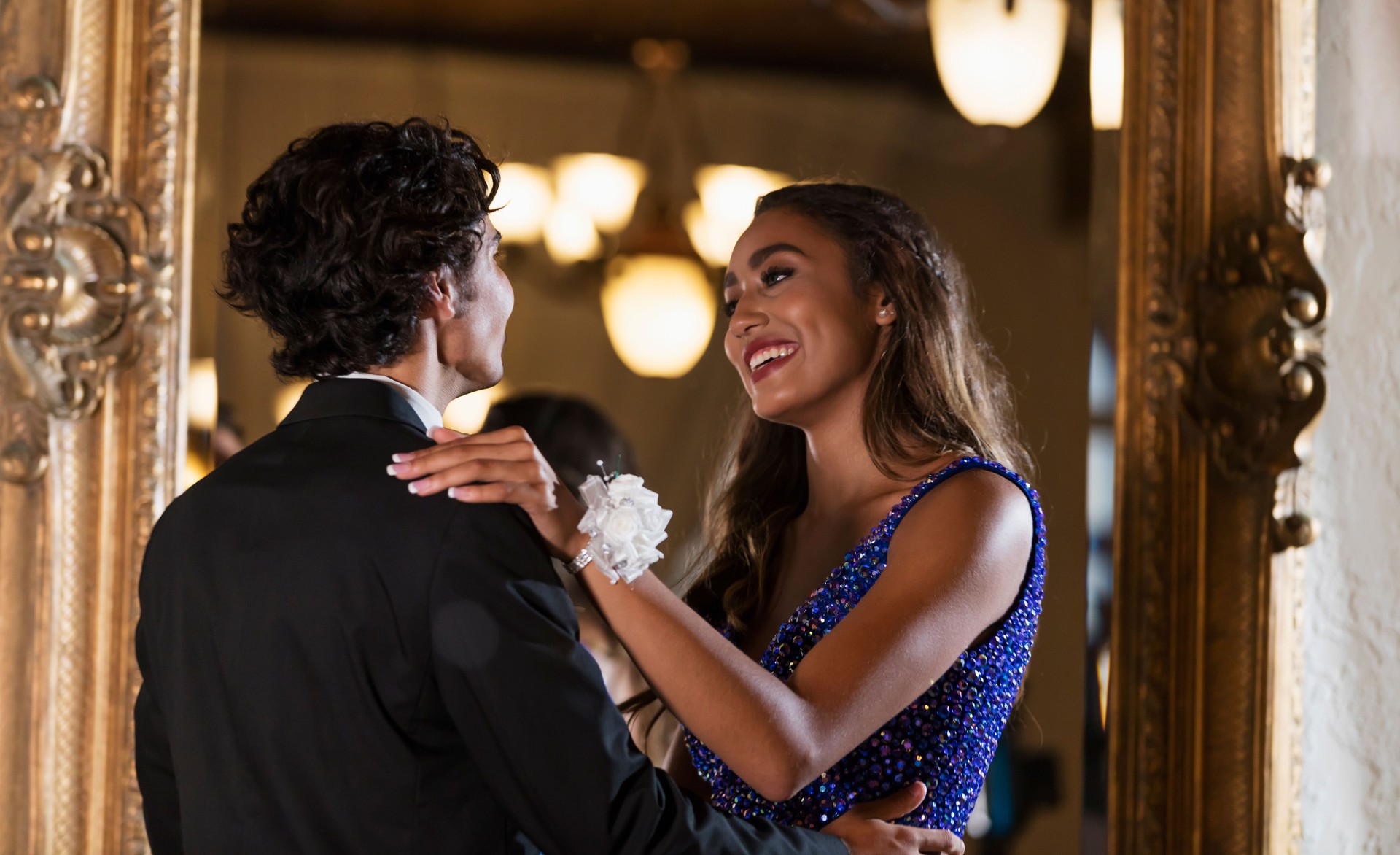 Teenage couple dressed for prom, slow dancing