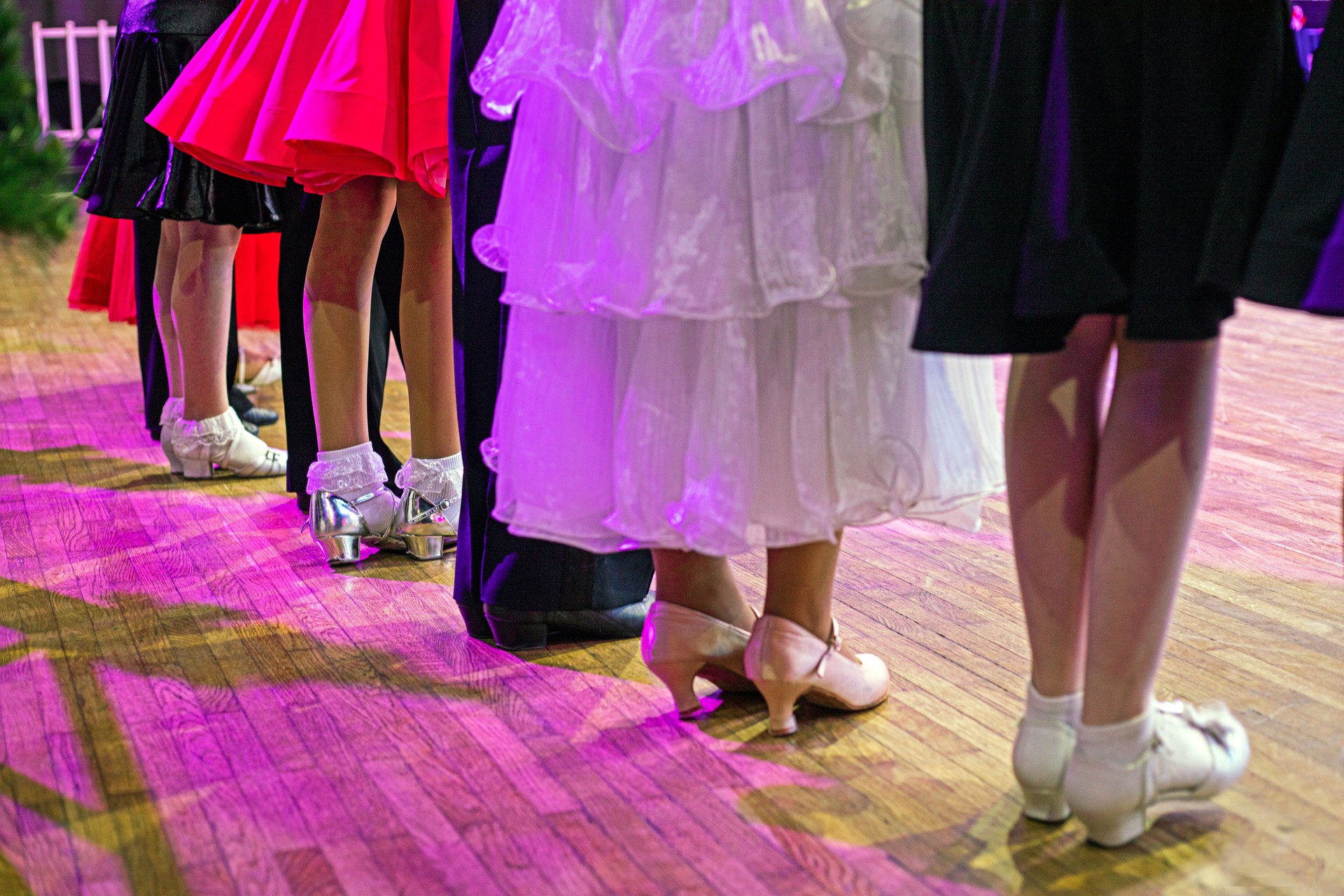 girls in beautiful dresses and shoes at the ballroom dancing tournament